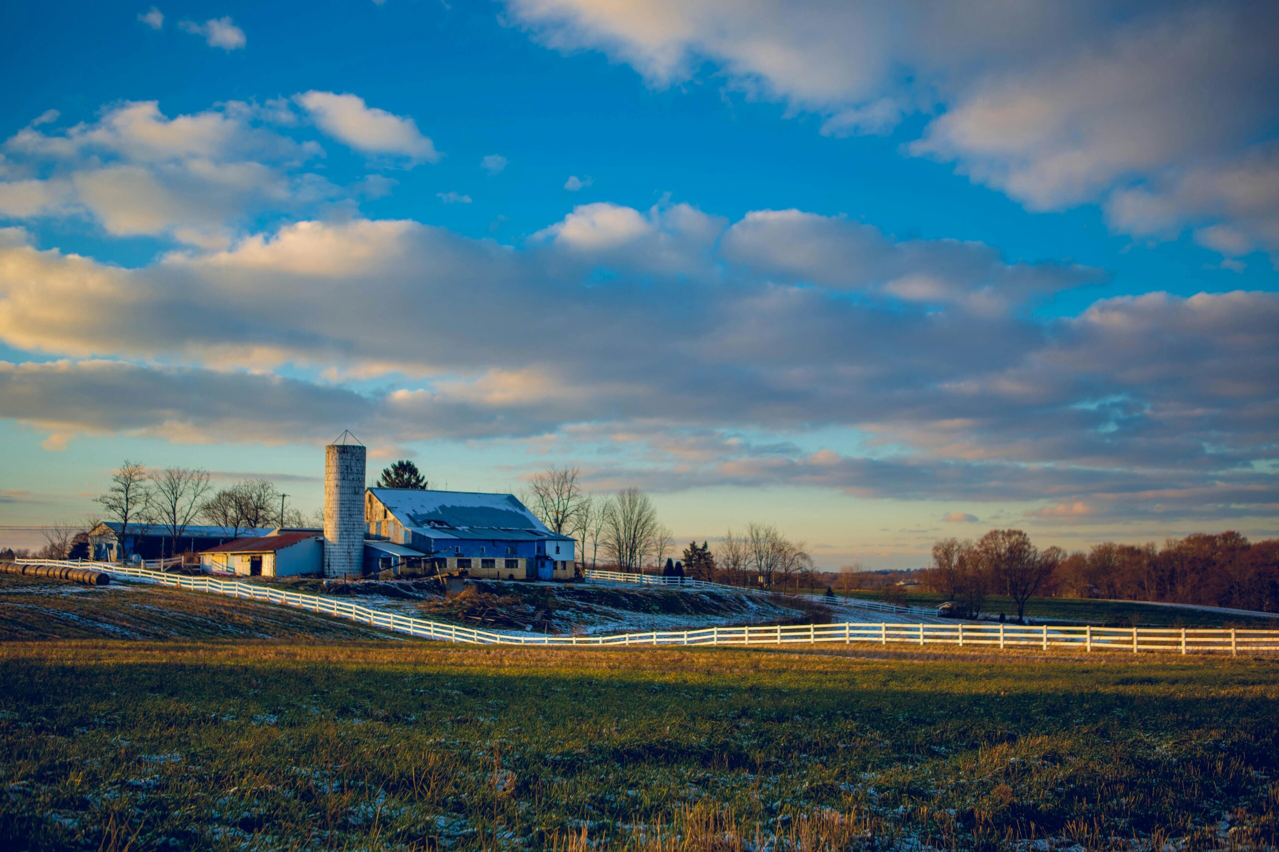 pexels photo 1671846 1671846 Picturesque rural farm landscape with an expansive sky and vibrant clouds.