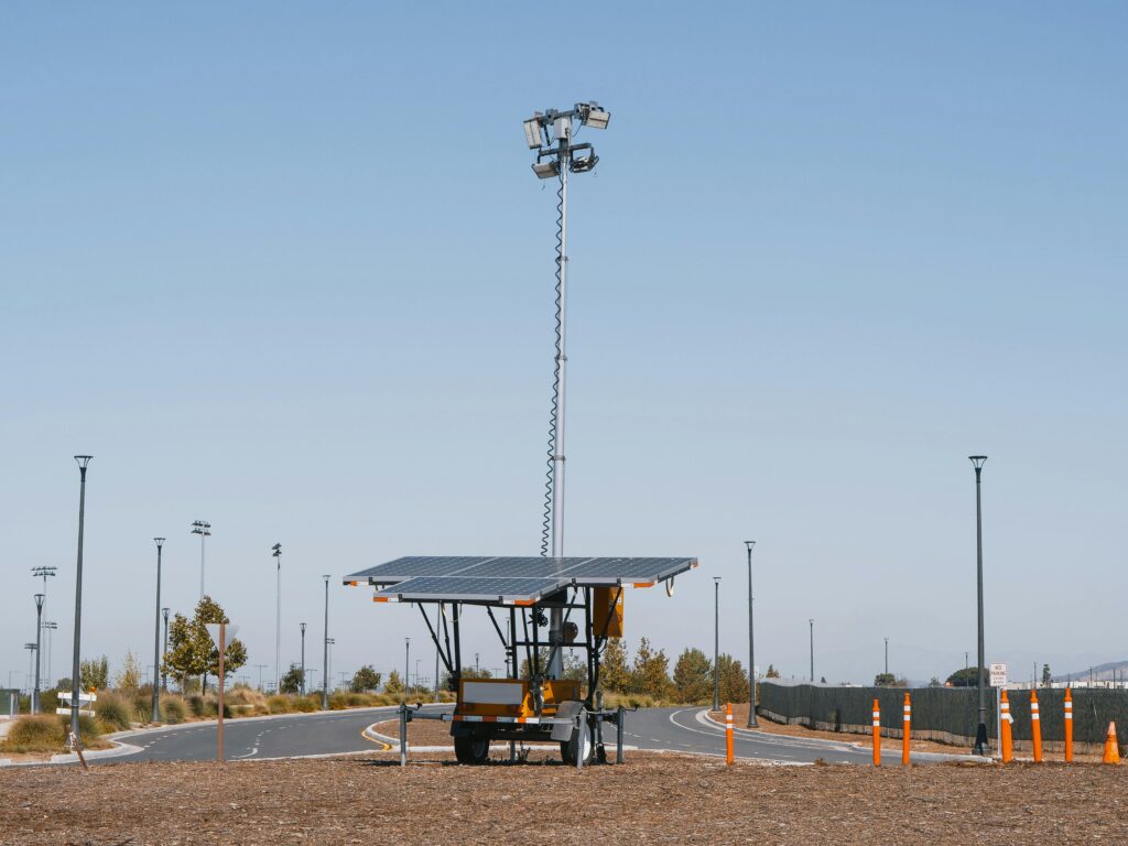 Services Solar powered streetlights under a clear blue sky, emphasizing renewable energy.